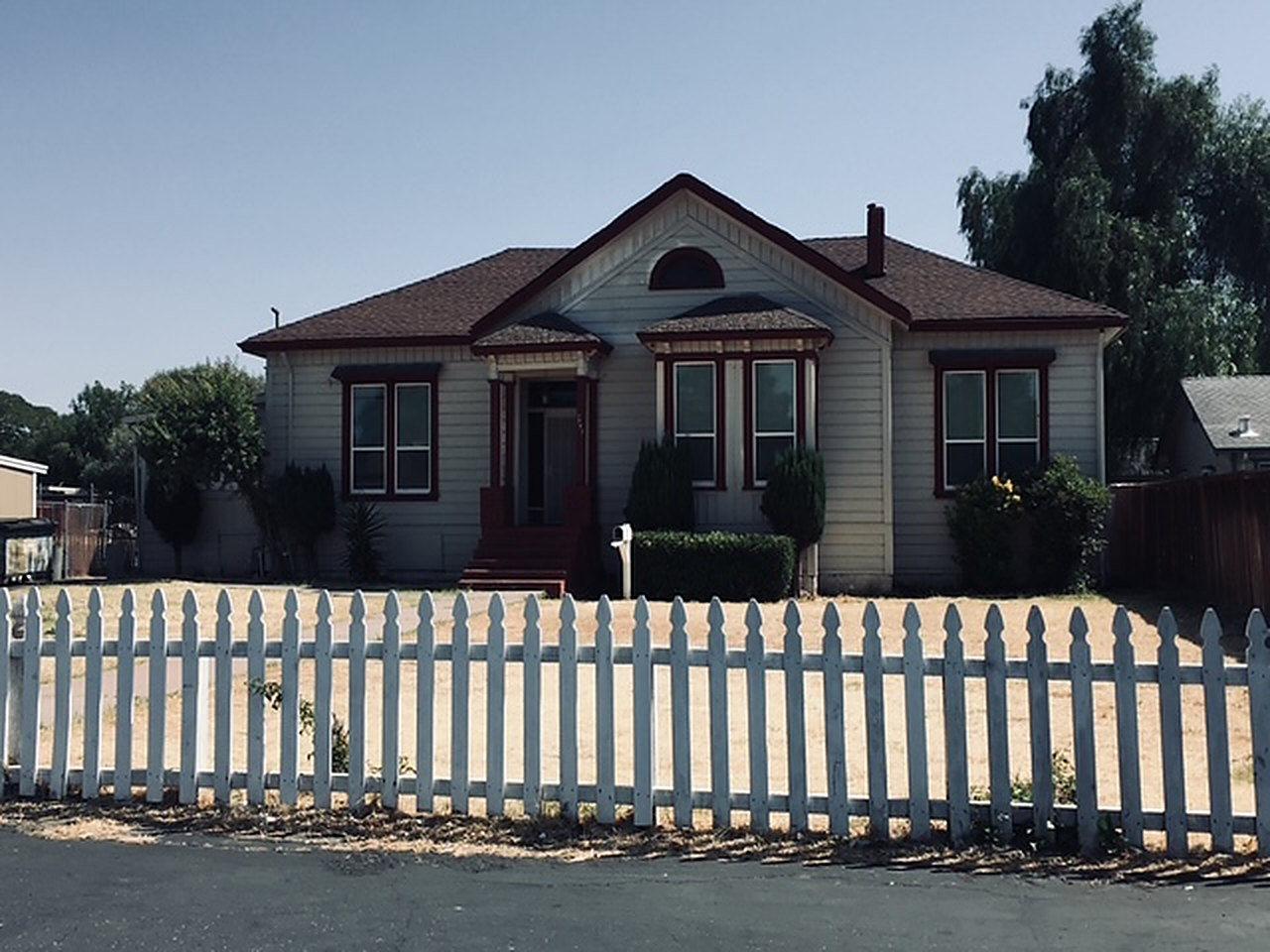 A single-storey wooden house with a white picket fence at 2777 Willow Pass Road, Bay Point, California