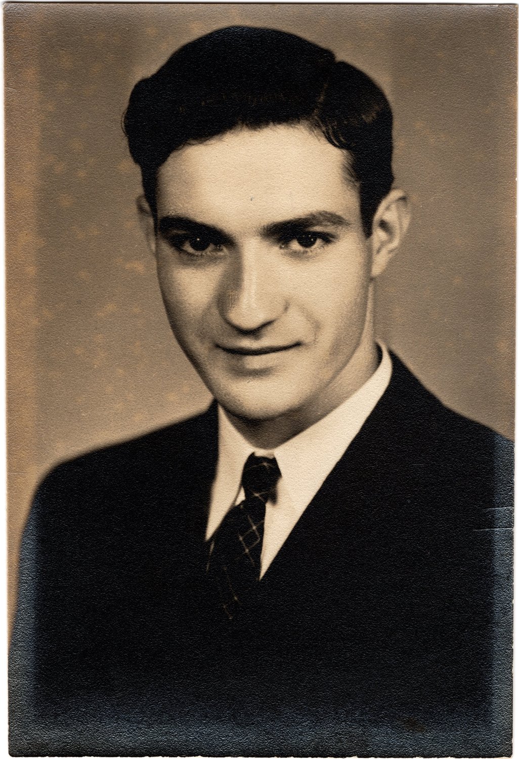 Sepia studio graduation portrait of Benedict F. Enea in a dark suit and patterned tie