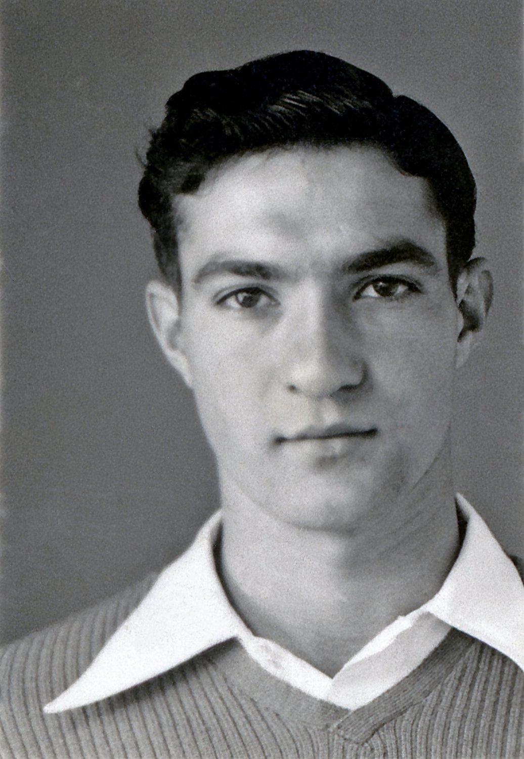 Studio portrait of a teenage Benny Enea in a ribbed sweater over an open white collar
