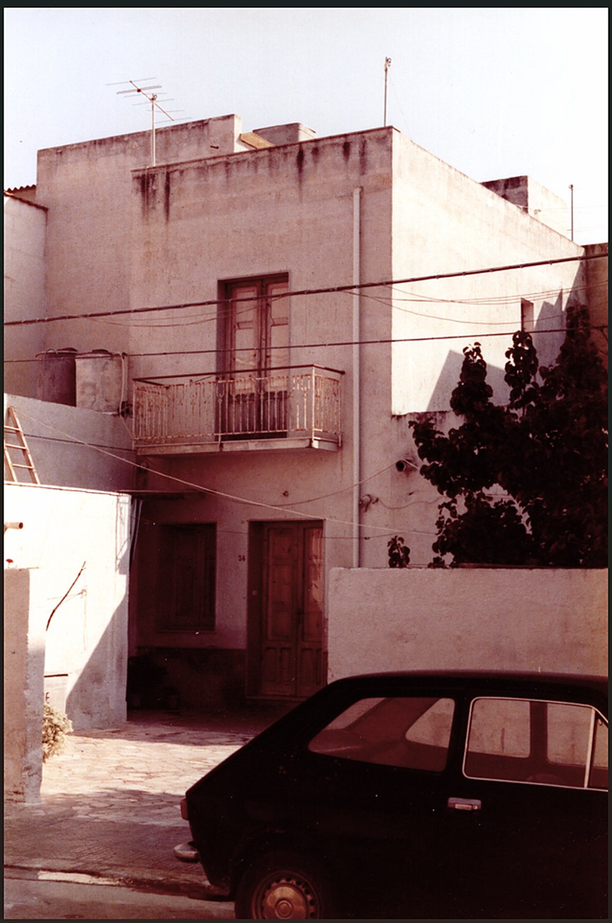 Circa-1980s photograph of the Enea family home in Trapani, with a balcony and a car in the foreground