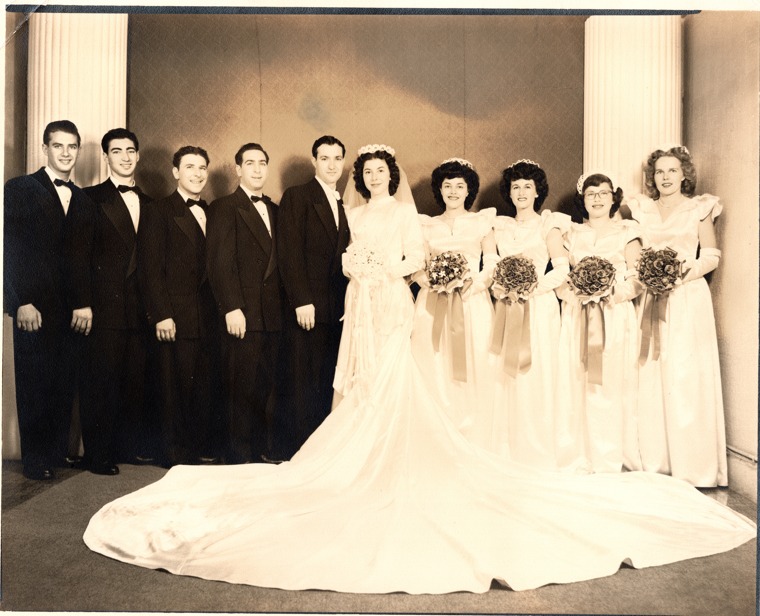 Formal wedding portrait of a bride and groom with five groomsmen and four bridesmaids