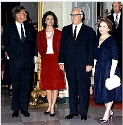 President and Mrs. Kennedy standing with Chief Justice Earl Warren and Nina Warren