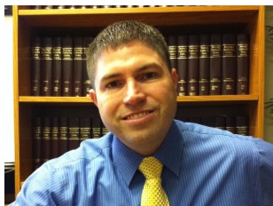 Portrait of attorney James White in front of law books