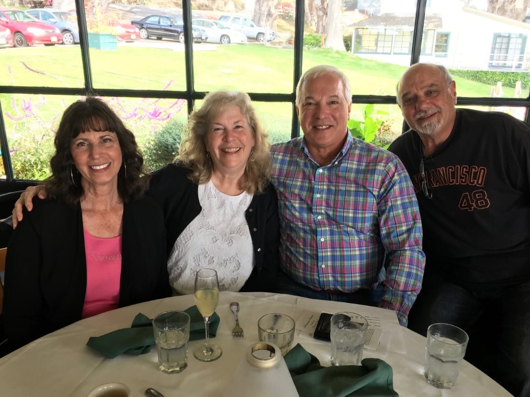 Four cousins seated together at a brunch table at Mission Ranch