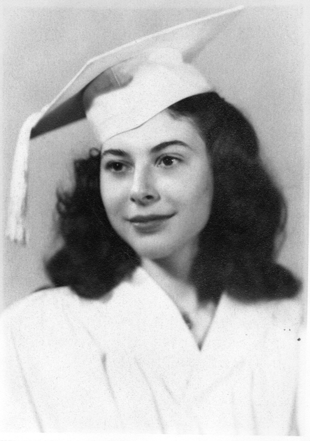 Graduation portrait of a young woman in a cap and gown