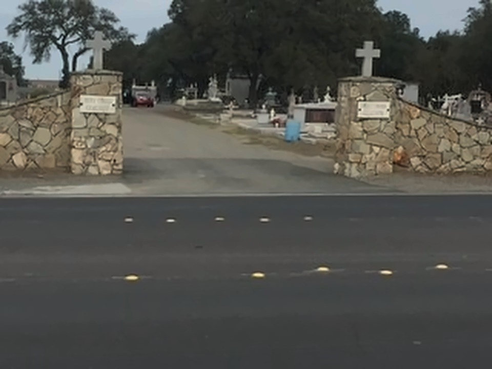 Closer view of the Holy Cross Cemetery gates, crosses set on each pillar