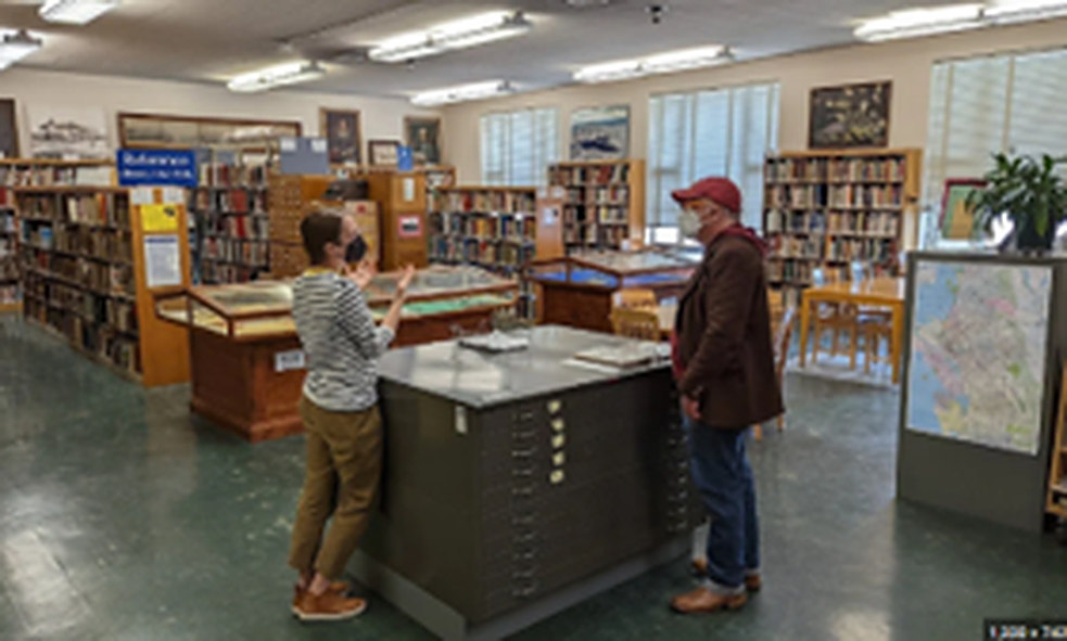 The Oakland History Room, with map cabinets, reading tables and shelves of bound volumes