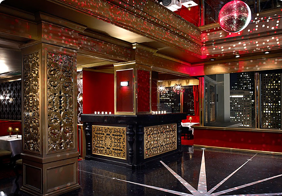 The Starlight Room, red and gold interior with a mirror ball and city lights through the windows